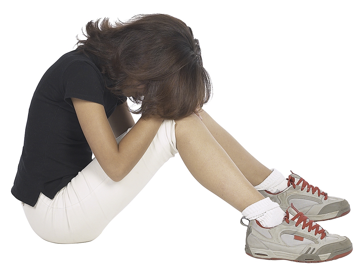 Photo of woman sitting hunched